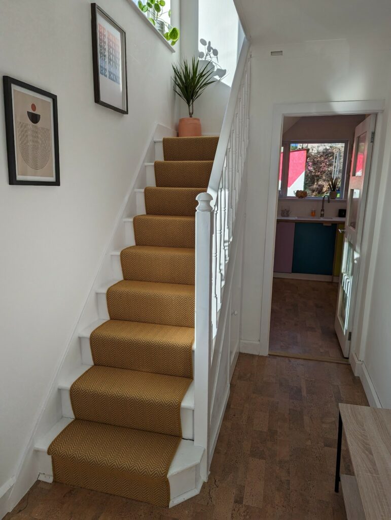 Gorse Chevron Wool Carpet runner on white staircase featured on Channel 4's Best home on the Street programme